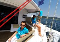 girls in cockpit of sailing multihull yacht